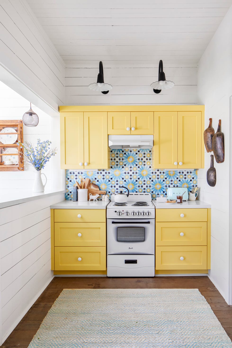 Small farmhouse kitchen with bright yellow cabinets