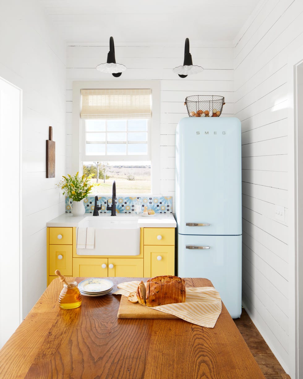 farmhouse kitchen with yellow cabinetry becca and david mcdowell’s farmhouse in muldoon, texas kitchen