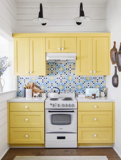 yellow cabinets and patterned tile in a small kitchen