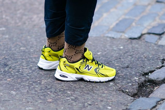 https://hips.hearstapps.com/hmg-prod/images/yellow-new-balance-sneakers-shoes-and-gucci-brown-monogram-news-photo-1578480246.jpg?resize=640:*