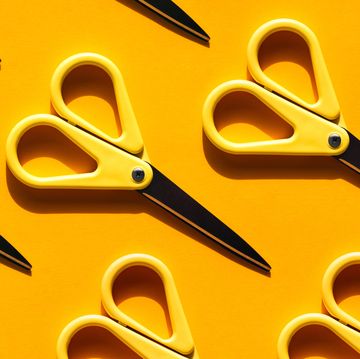 yellow scissors with shadow on illuminating yellow background back to school concept trendy colors of the year