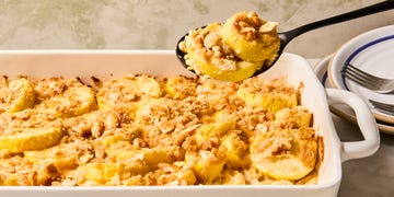 sliced yellow squash in a casserole topped with crushed ritz crackers on top