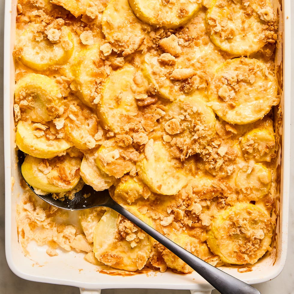 sliced yellow squash in a casserole topped with crushed ritz crackers
