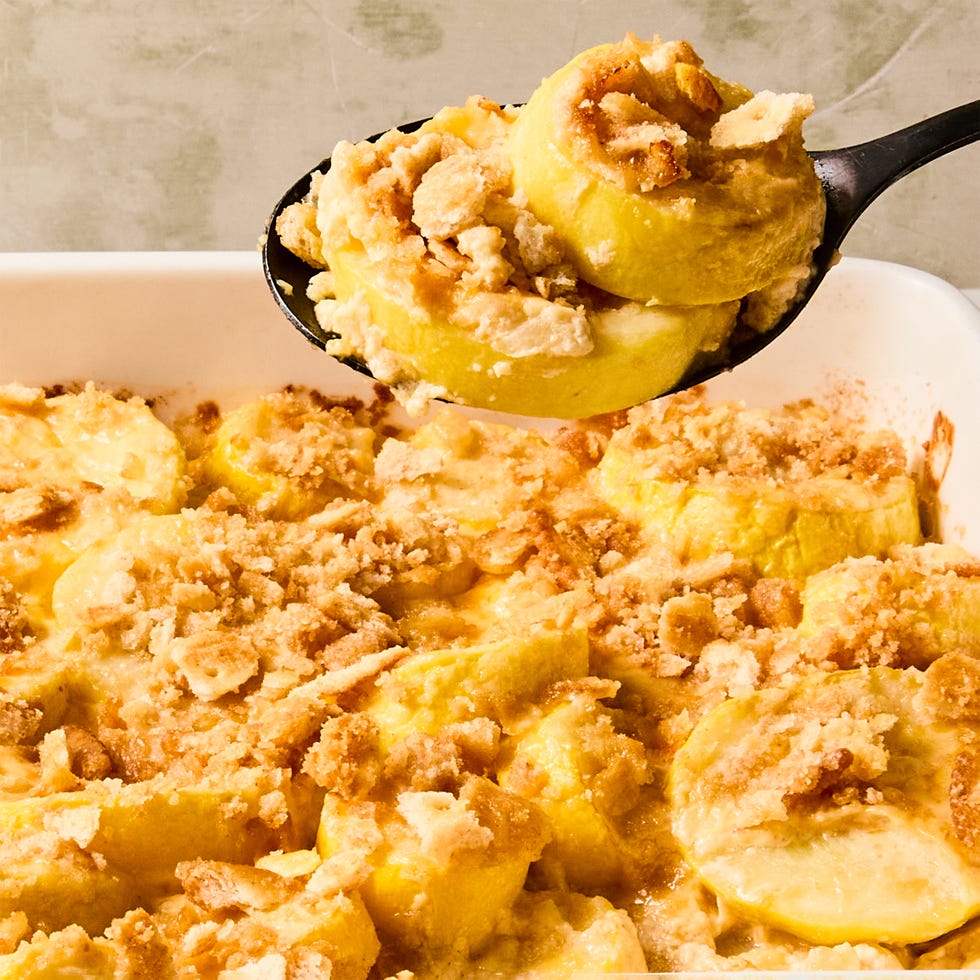 sliced yellow squash in a casserole topped with crushed ritz crackers