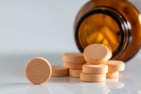 yellow vitamin pills isolated on a white background