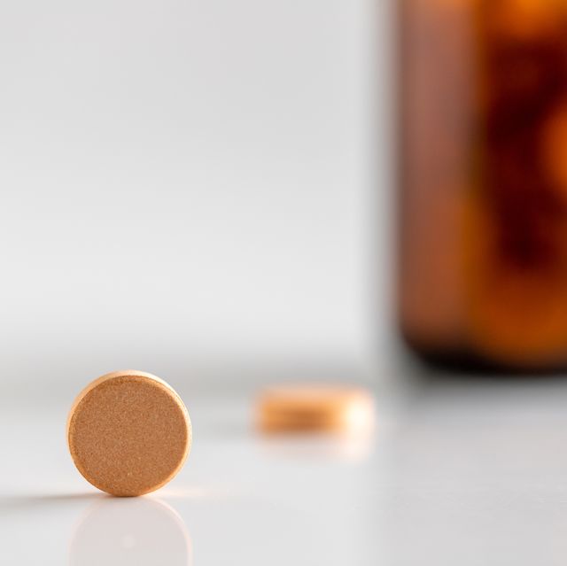 yellow vitamin pills isolated on a white background
