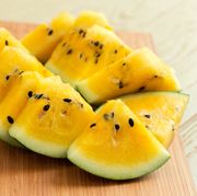yellow watermelon sliced on wooden background