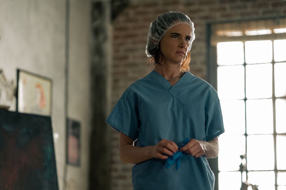 juliette lewis wears scrubs and a hairnet in a scene from yellowjackets
