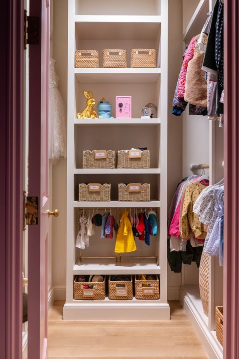 a closet with clothes and baskets