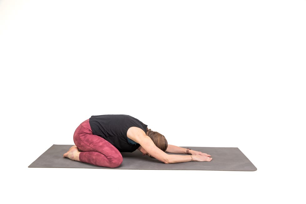 a woman doing a yoga post against a white background