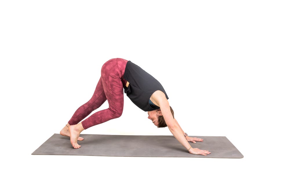 a woman doing a yoga post against a white background