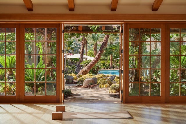 a room with glass doors and a view of the ocean