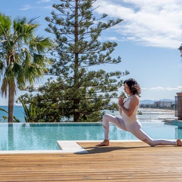 a woman in a white outfit by a pool a woman in a white outfit by a pool
