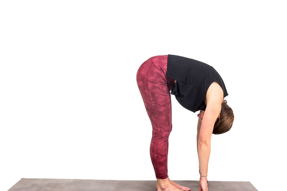 a woman doing a yoga post against a white background