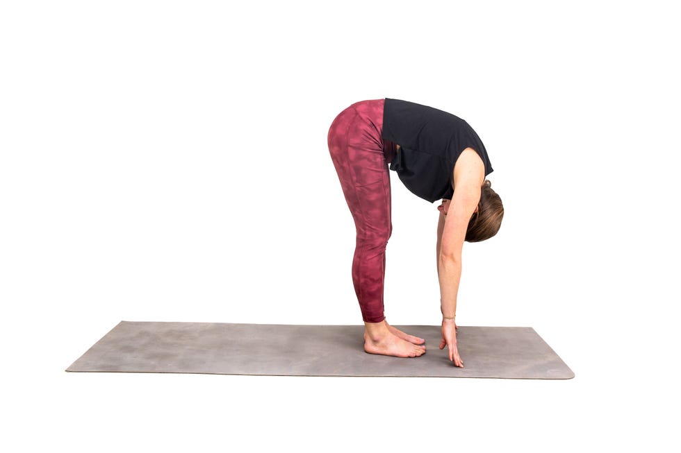 a woman doing a yoga post against a white background