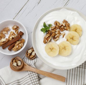 een bakje plantaardige yoghurt met noten en banaan