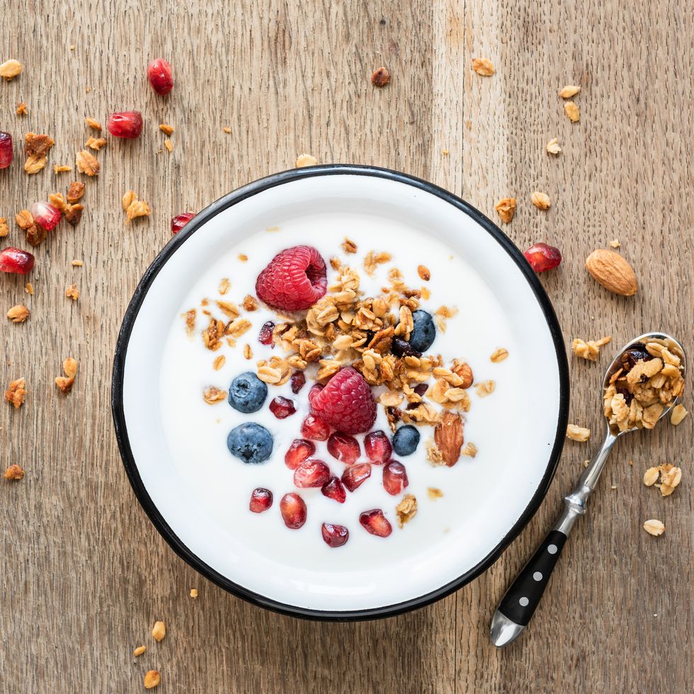 yogurt with granola, pomegranate seed and berries