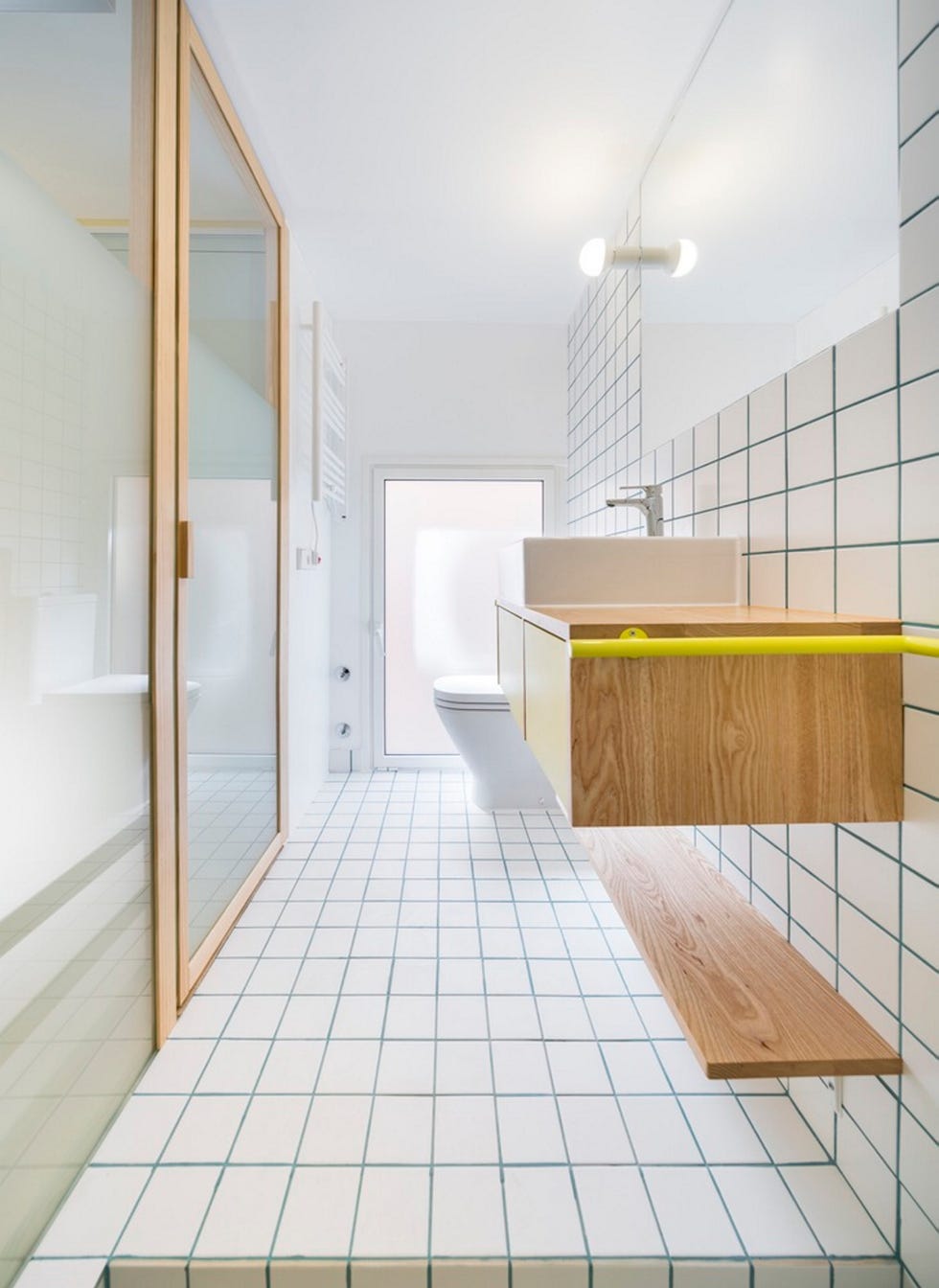 apartamento pequeño con un baño dividido con una puerta de cristal para dejar entrar la iluminación natural, de elii arquitectura