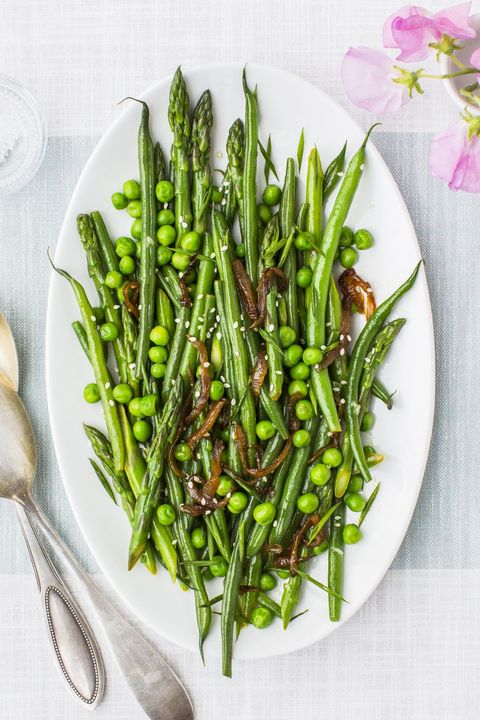 lemony asparagus, beans and peas on a white oval platter