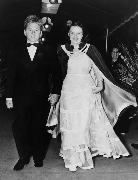 Young actors Mickey Rooney and Judy Garland arrive at a movie premiere...