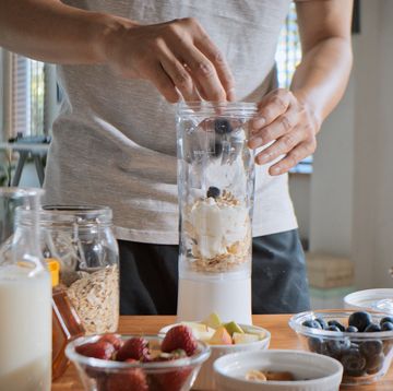 young adult asian man prepare and make protein shake drink, mixed fruit cereal juice, using blender mixer. fitness dietary activity, healthy diet lifestyle, health care nutrition concept