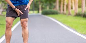young adult male with muscle pain during running runner have leg ache due to groin pull sports injuries and medical concept