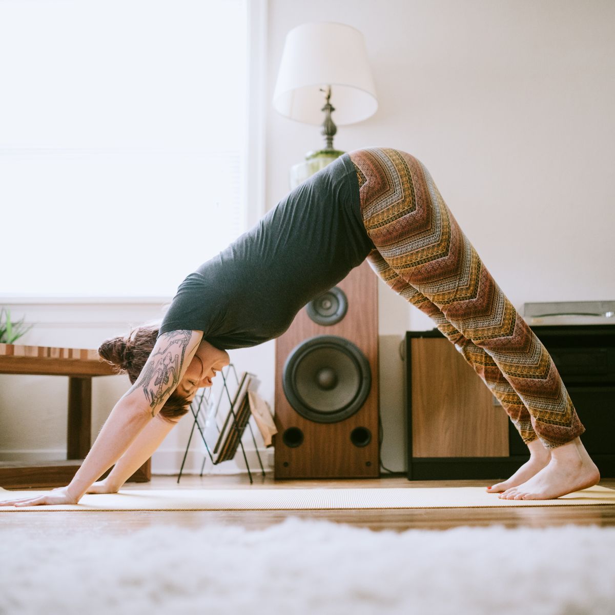 Young Adult Woman At Home Practicing Yoga