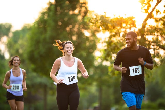 young adults running a marathon stock photo