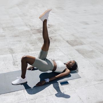 street workout young african american doing bridge on yoga mat