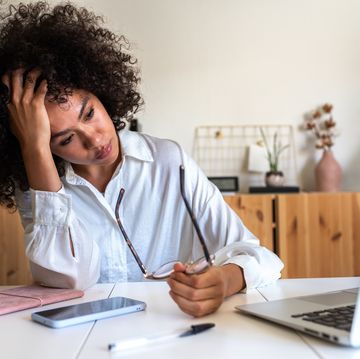 woman feeling exhausted and depressed sitting in front of laptop work burnout syndrome
