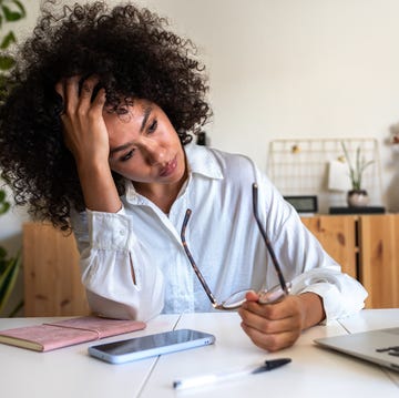 woman feeling exhausted and depressed sitting in front of laptop work burnout syndrome