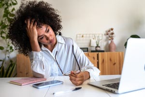 woman feeling exhausted and depressed sitting in front of laptop work burnout syndrome