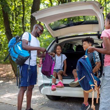 young african family getting ready for hiking from car