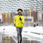 young african woman training outdoors in bad weather