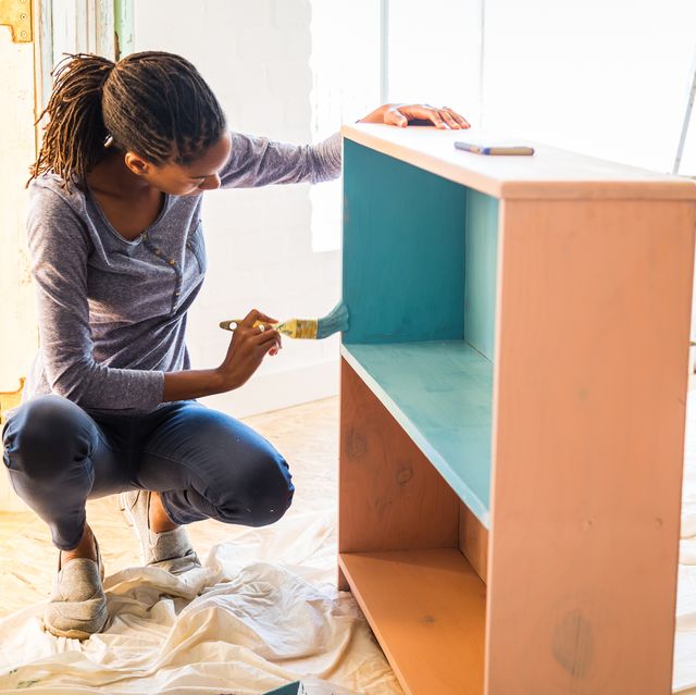 young caribean woman renovating her home