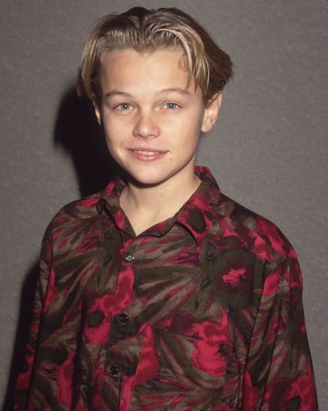 leonardo dicaprio as a child, wearing a red patterned button shirt