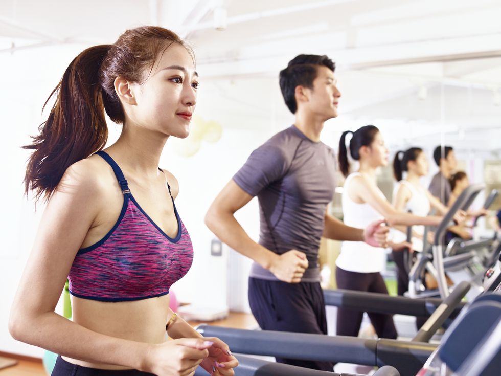 young asian adults exercising in gym