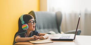 young asian cute girl studying with laptop at home during pandemic