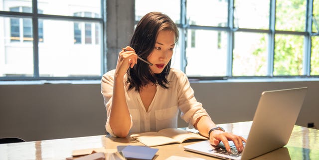 A young Asian lady is sitting at the table