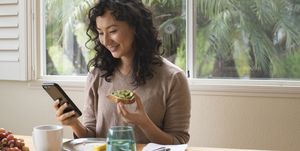 young asian woman eating a healthy breakfast