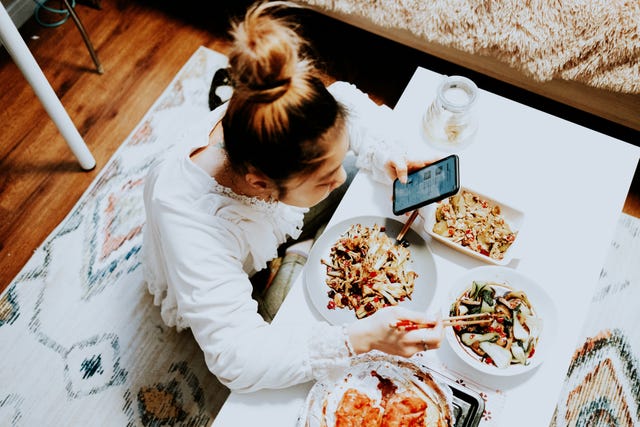 young asian woman enjoying chinese food in bedroom