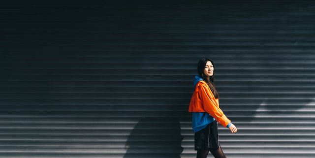https://hips.hearstapps.com/hmg-prod/images/young-asian-woman-in-colorful-clothes-walks-along-a-royalty-free-image-1747386203.pjpeg?crop=1.00xw:0.752xh;0,0.231xh&resize=640:*