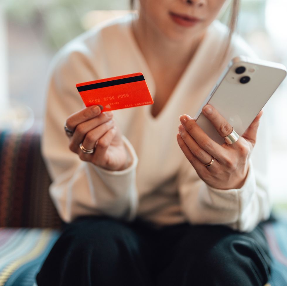 young asian woman making card payment via smartphone