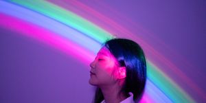young asian woman on rainbow background