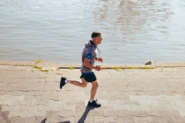 young athlete running alone in park