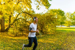 young athlete running in public park