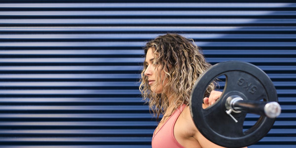 https://hips.hearstapps.com/hmg-prod/images/young-athlete-with-barbell-by-blue-corrugated-wall-royalty-free-image-1754510211.pjpeg?crop=1.00xw:0.752xh;0,0.130xh&resize=1200:*