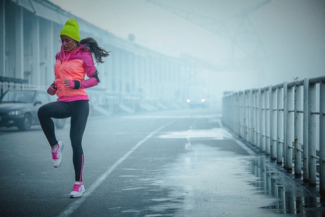 Young athlete woman exercises bouncing up and down outdoors