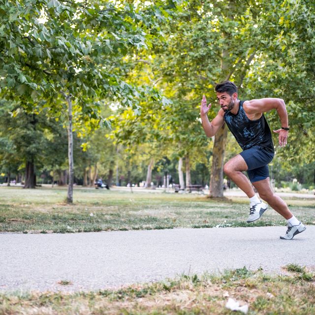 young athletic man running at the park