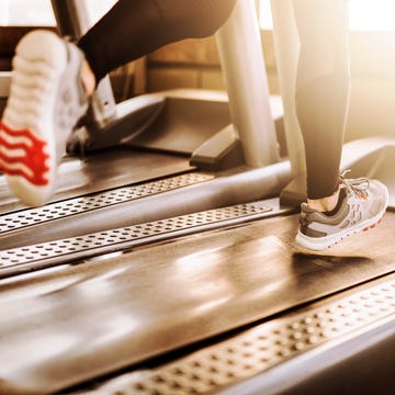 Young athletic man running on treadmill legs close up young athletic man running on treadmill legs close up